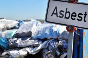 waste of asbestos on dump site. Ecology background or texture concept. Scrap yard scenery.